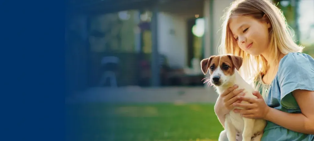 Girl playing with dog in mosquito free yard