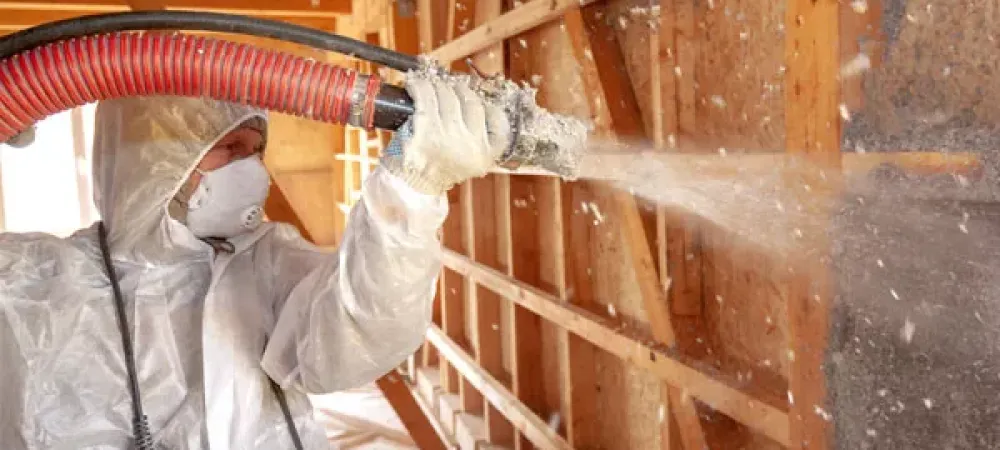 Tech spraying insulation