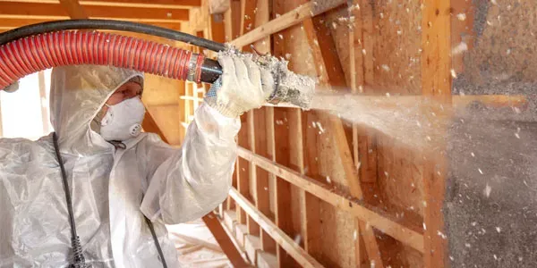 Tech spraying insulation